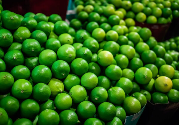 there are many green fruits that are on display in the store. generative ai.